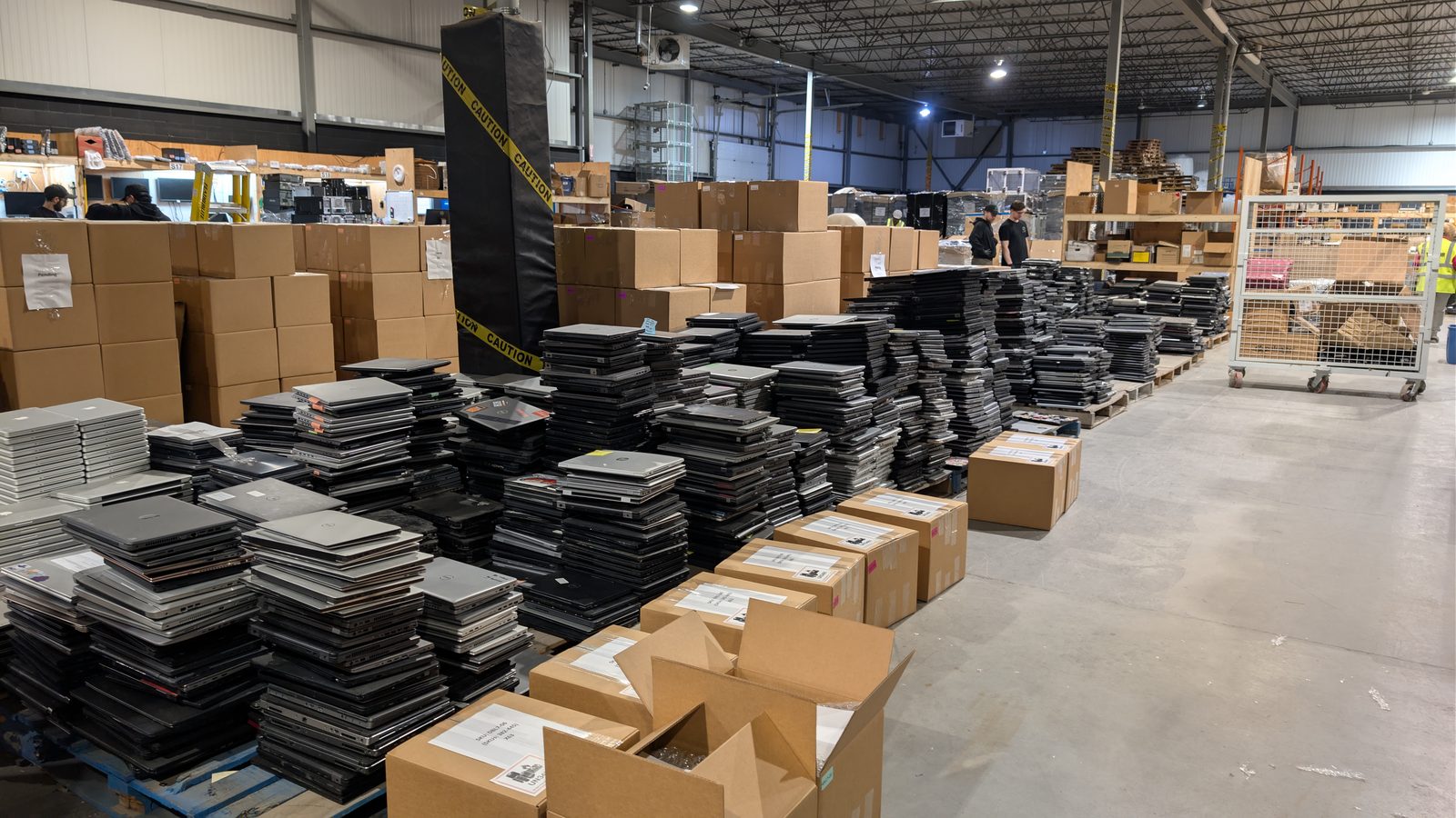 Stacks of donated laptops awaiting refurbishment